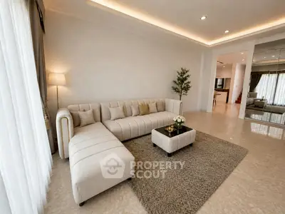 Spacious modern living room with elegant beige sectional sofa and cozy decor