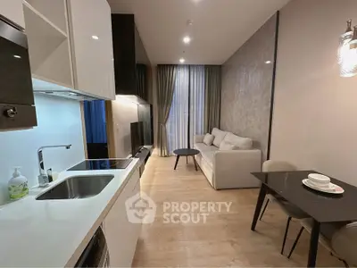 Modern open-plan living room with sleek kitchen and cozy seating area, perfect for urban living.