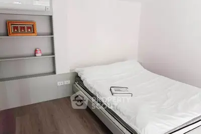 Cozy minimalist bedroom with built-in shelves and modern decor