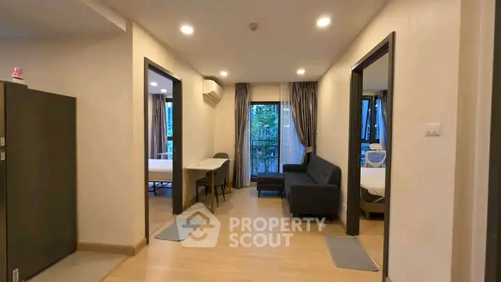 Spacious apartment living room with modern decor and balcony view.