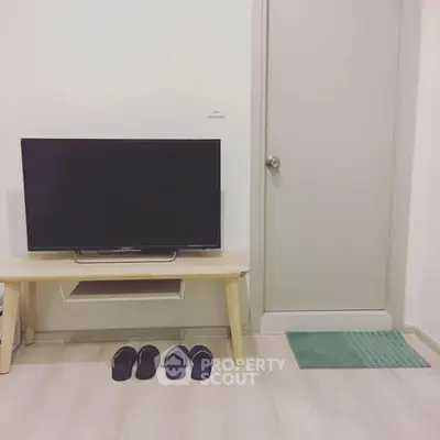 Cozy living room with minimalist TV setup and wooden flooring