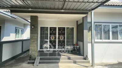 Charming modern house entrance with decorative glass doors and covered porch