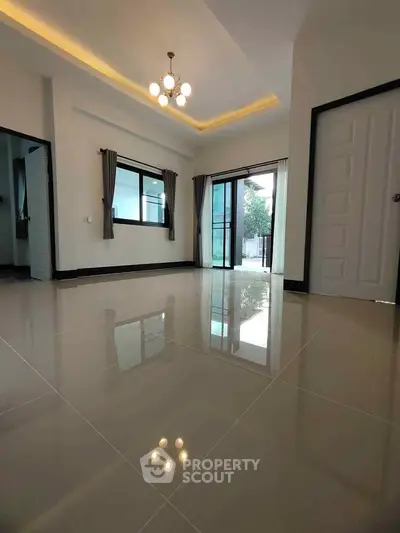 Spacious modern living room with glossy tiled floors and elegant lighting