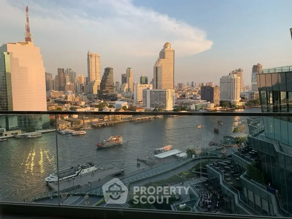 Stunning riverfront cityscape view from a high-rise balcony, showcasing urban skyline and serene waterway.