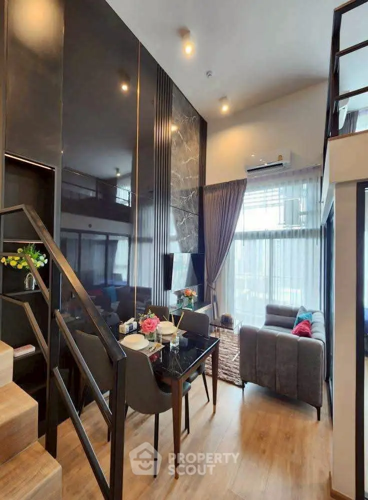 Modern duplex living room with high ceiling and stylish decor