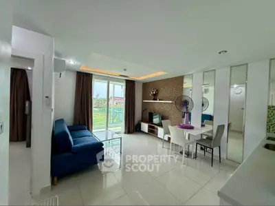 Spacious modern living room with elegant decor and large windows offering natural light and scenic views.