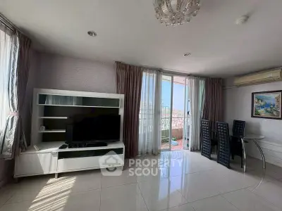Spacious living room with modern decor and balcony access in a bright apartment.