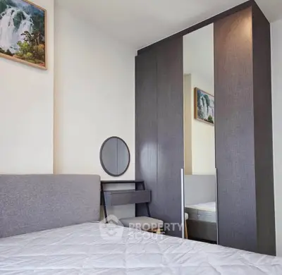 Modern bedroom with stylish wardrobe and cozy bed setup.