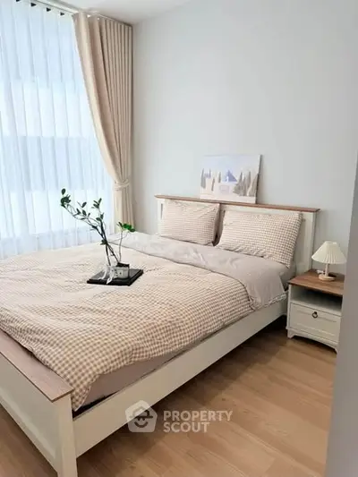 Cozy bedroom with stylish decor and natural light, perfect for relaxation and comfort.