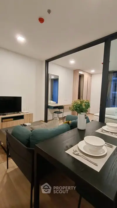 Modern living room with dining area and stylish decor in a contemporary apartment.