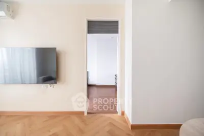 Modern interior with wall-mounted TV and wooden flooring