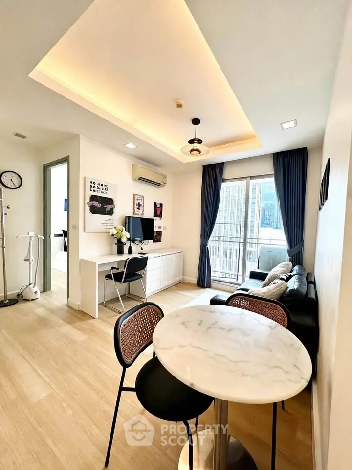 Modern living room with stylish decor and balcony view in a contemporary apartment.