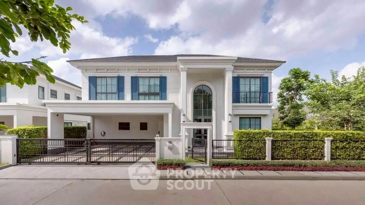 Luxurious two-story house with elegant facade and spacious driveway in a serene neighborhood.