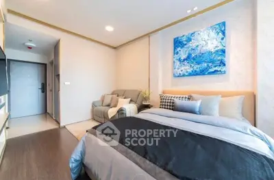 Modern bedroom with stylish decor and cozy seating area, perfect for relaxation.