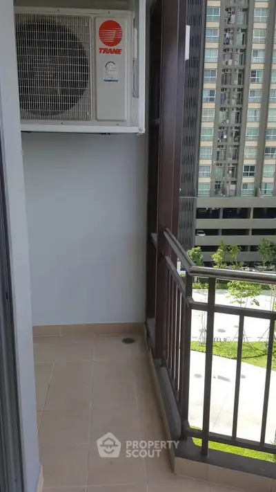 Modern apartment balcony with air conditioning unit and city view