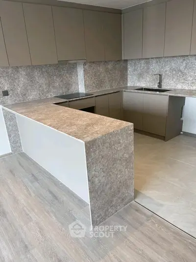 Modern kitchen with sleek cabinetry and open layout design