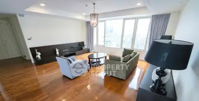 Spacious living room with modern furniture and large windows offering city views.