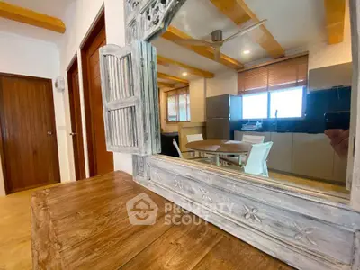 Charming kitchen with rustic wooden accents and modern dining area, perfect for cozy gatherings.