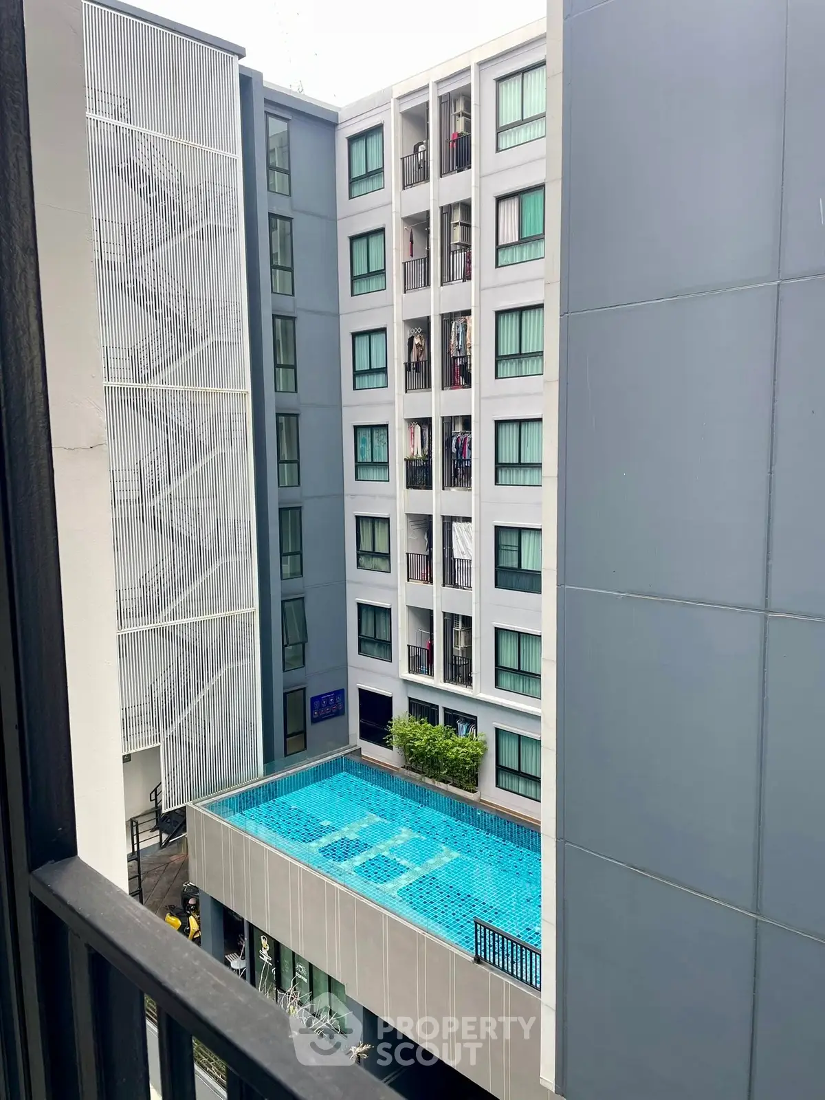 Modern apartment building with rooftop pool and sleek design