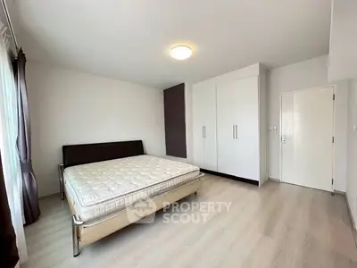 Spacious bedroom with modern design and ample natural light