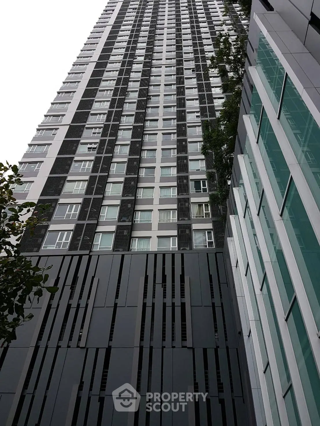 Modern high-rise building with sleek architectural design and glass facade.