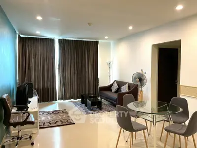 Spacious modern living room with elegant decor and ample natural light, perfect for relaxation and entertainment.