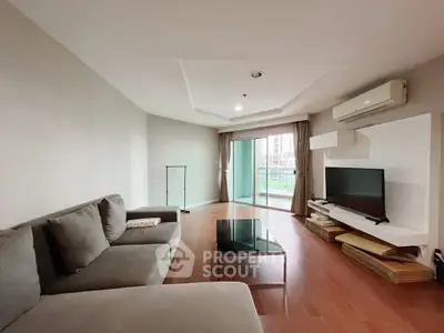 Spacious living room with modern decor and balcony access