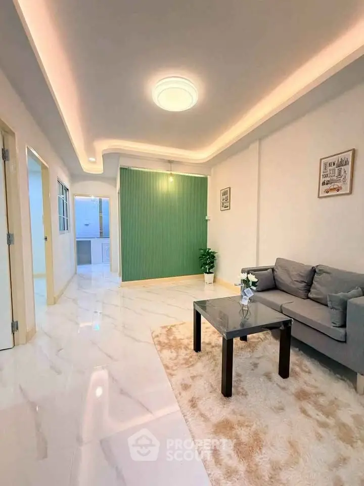 Modern living room with stylish lighting and elegant decor in a contemporary apartment.