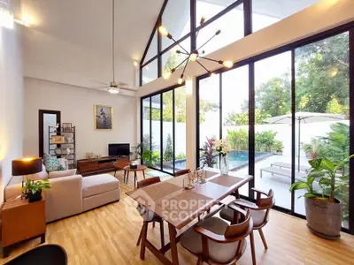 Stunning open-plan living room with pool view and modern decor
