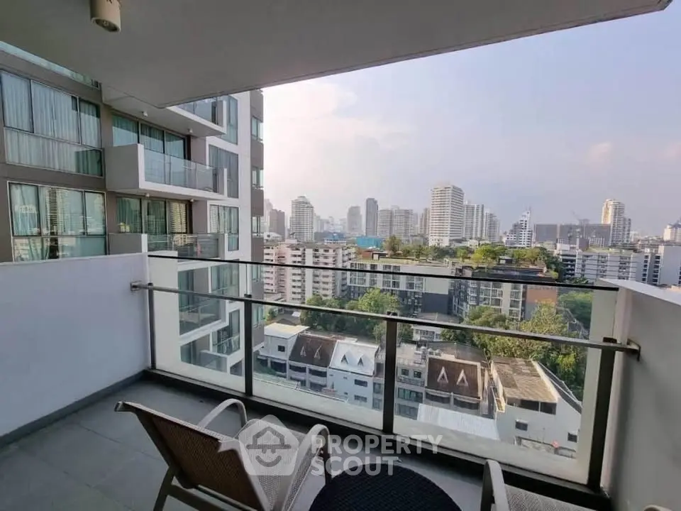 Spacious balcony with stunning city view in modern high-rise apartment.