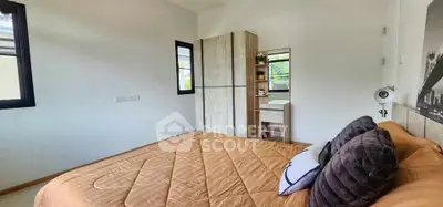 Cozy bedroom with modern decor and ample natural light