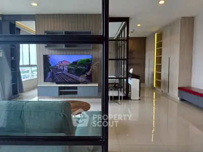Spacious modern living room with large TV and stylish decor