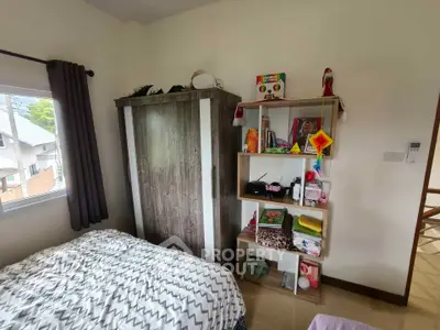 Cozy bedroom with wardrobe and shelving, ideal for small spaces