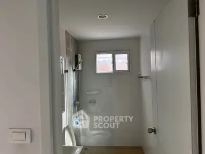 Compact bathroom with modern fixtures and natural light