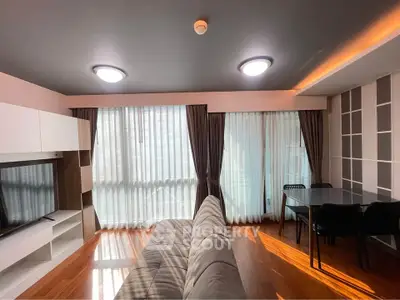 Modern living room with sleek furniture and large windows for natural light