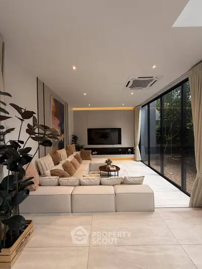 Luxurious modern living room with large windows and stylish decor, perfect for relaxation and entertainment.