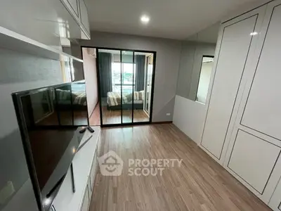 Modern apartment interior with sleek design and spacious layout, featuring a cozy bedroom and stylish living area.