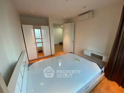 Spacious bedroom with modern furnishings and natural light