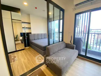 Modern bedroom with balcony view and stylish furnishings in a contemporary apartment.