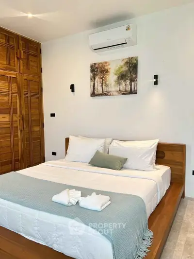 Elegant bedroom with wooden accents and modern air conditioning unit.