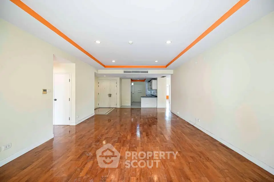 Spacious open layout living room with hardwood floors and modern lighting