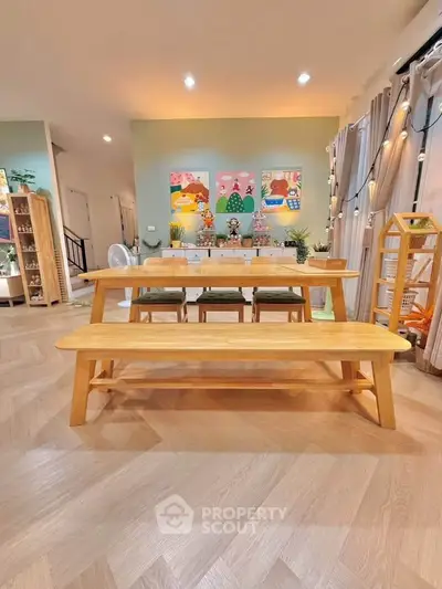 Spacious living room with modern decor and wooden furniture, perfect for family gatherings.