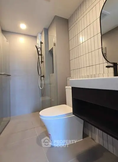 Modern bathroom with sleek fixtures and glass shower enclosure