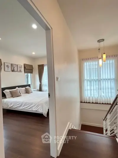 Charming bedroom with elegant decor and natural light, perfect for a cozy retreat.