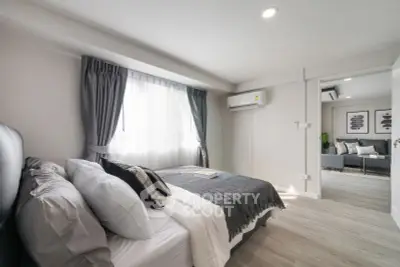 Modern bedroom with stylish decor and natural light in a contemporary apartment.
