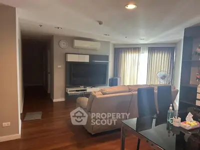 Spacious living room with modern furniture and large TV, perfect for relaxation.