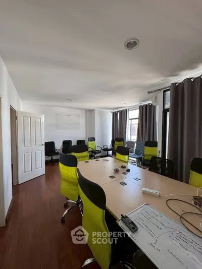 Spacious modern conference room with stylish chairs and large windows.