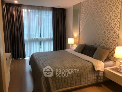Elegant bedroom with stylish decor and large window in modern apartment.