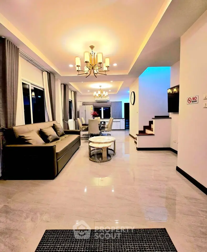 Luxurious open-plan living room with elegant lighting and modern decor