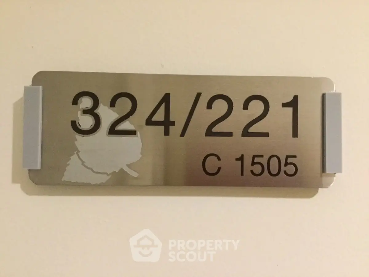 Apartment number sign on a wall indicating unit 324/221 C 1505.